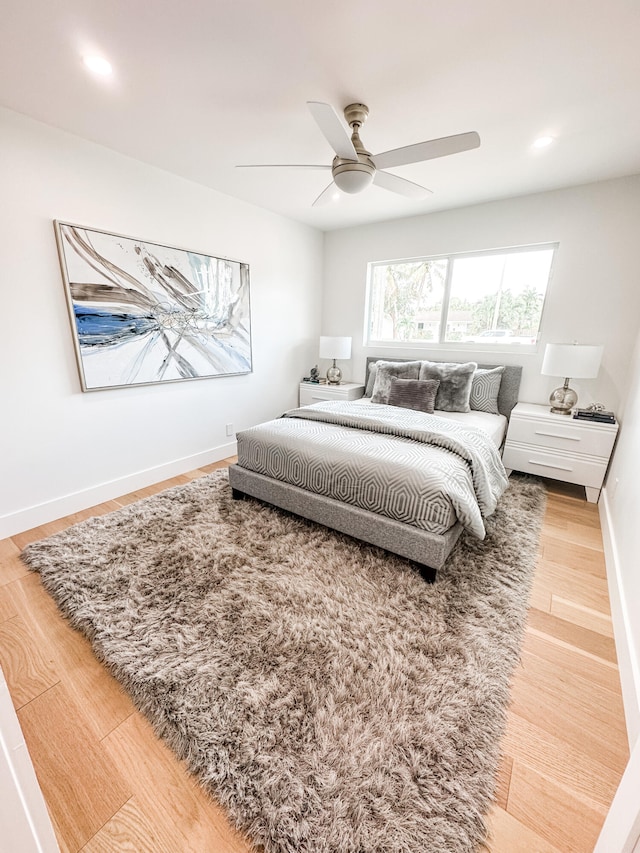 bedroom with hardwood / wood-style flooring and ceiling fan