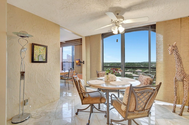 dining room with a wall of windows, a textured ceiling, light tile patterned floors, and ceiling fan