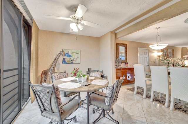 dining area with a textured ceiling and ceiling fan