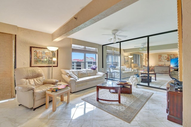 living room with ceiling fan and beam ceiling