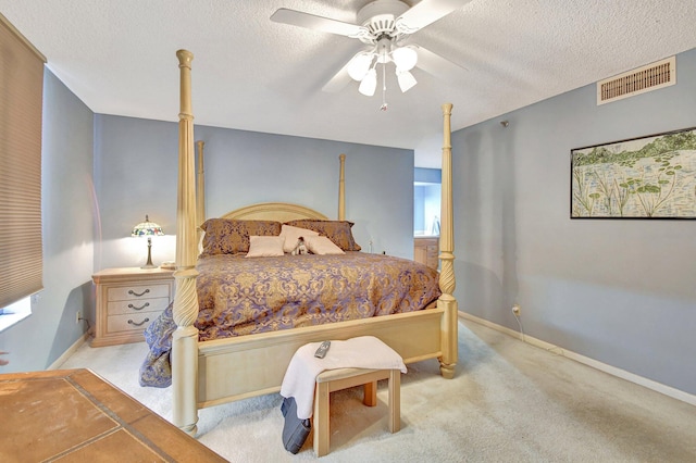 carpeted bedroom with a textured ceiling and ceiling fan