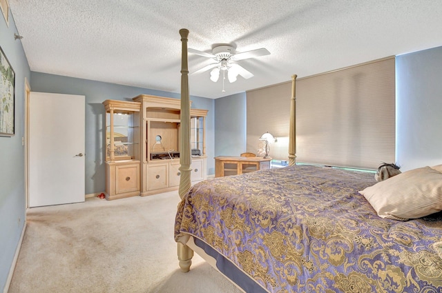 carpeted bedroom with a textured ceiling and ceiling fan