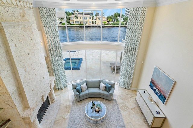 living room with a water view and ornamental molding