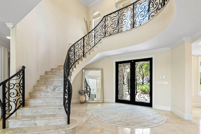 entryway featuring a wealth of natural light, french doors, and crown molding