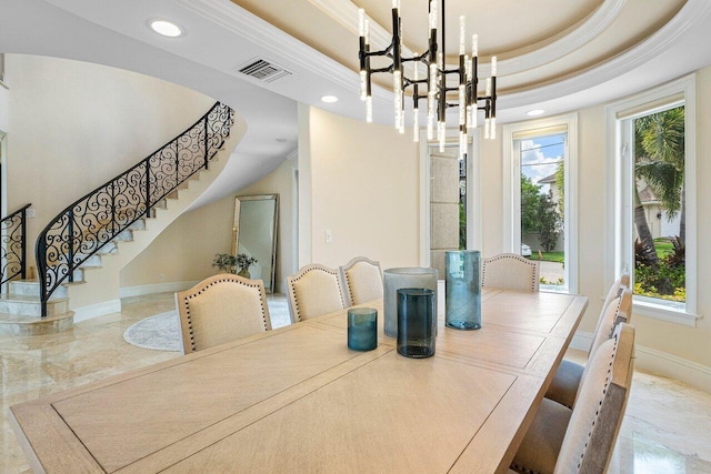 dining room featuring a raised ceiling and a chandelier