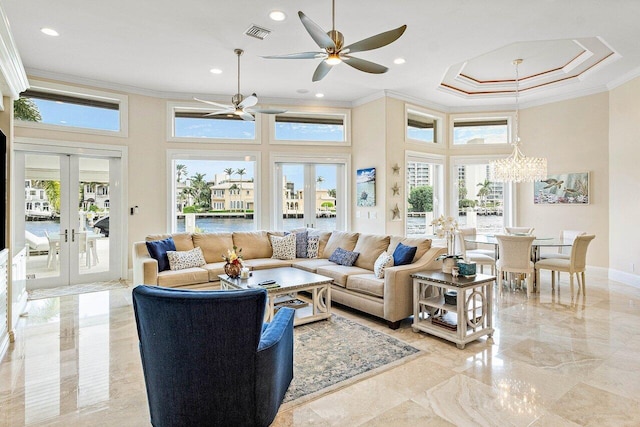 living room featuring french doors, crown molding, a towering ceiling, and ceiling fan with notable chandelier