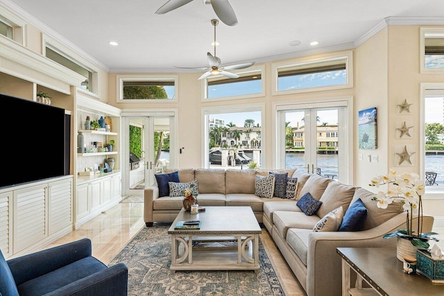 living room with a towering ceiling, french doors, and plenty of natural light