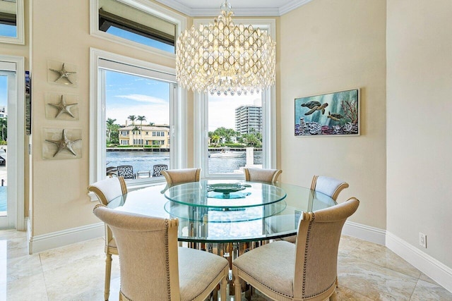 dining area featuring crown molding, a water view, and an inviting chandelier