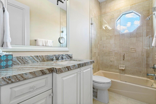 full bathroom with vanity, combined bath / shower with glass door, toilet, and tile patterned flooring