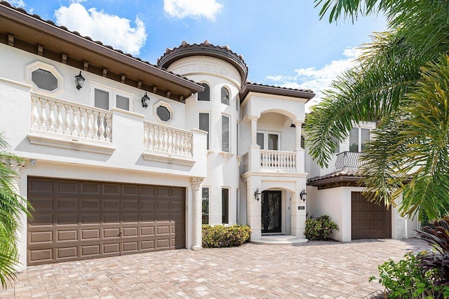 mediterranean / spanish-style home with a balcony and a garage