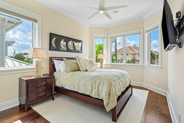 bedroom featuring dark hardwood / wood-style flooring, crown molding, and ceiling fan