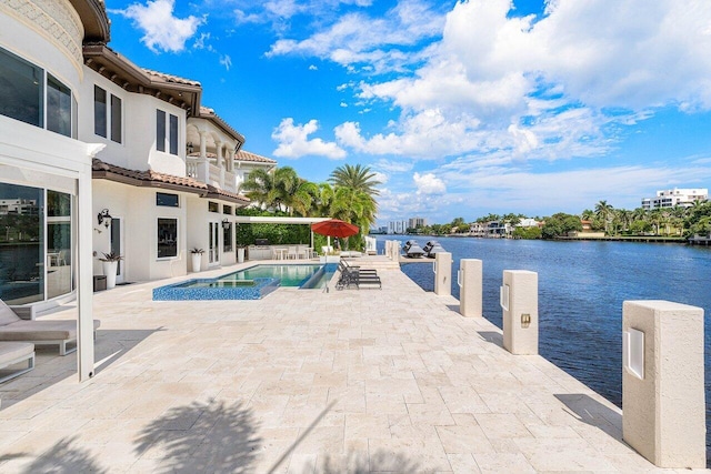 view of pool featuring a patio and a water view