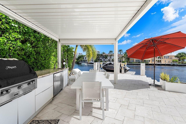 view of patio featuring a water view and a boat dock