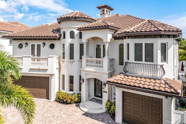 mediterranean / spanish-style home with a balcony and a garage