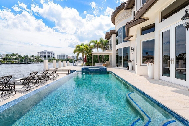 view of pool with a patio and a water view