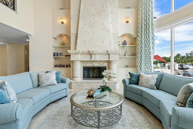 tiled living room with built in features, a high ceiling, and a high end fireplace