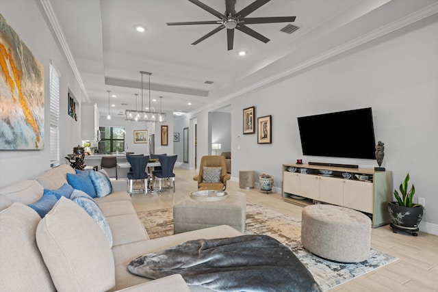 living room featuring ceiling fan, crown molding, and light hardwood / wood-style floors