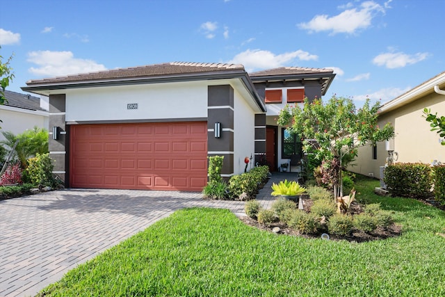 view of front of home featuring a garage and a front lawn