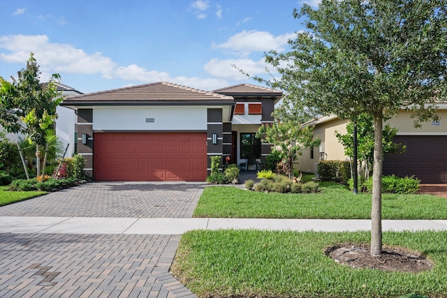 view of front of home with a garage and a front lawn