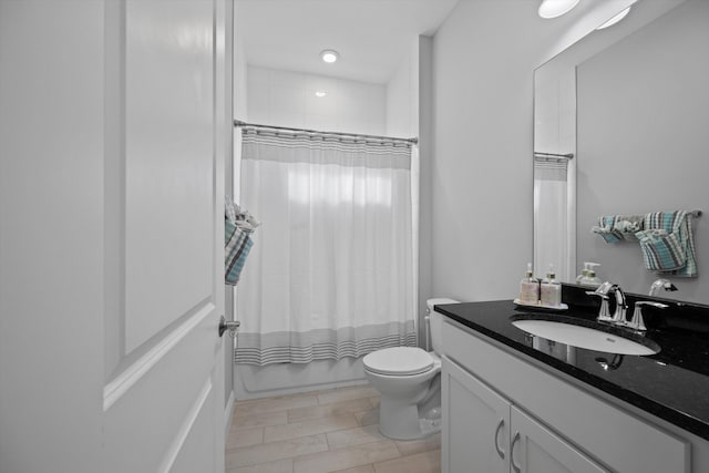 full bathroom with toilet, vanity, and shower / bath combination with curtain