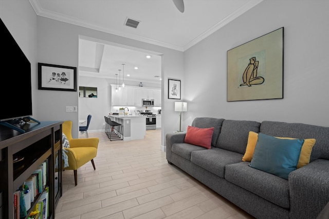 living room featuring ornamental molding and light hardwood / wood-style flooring