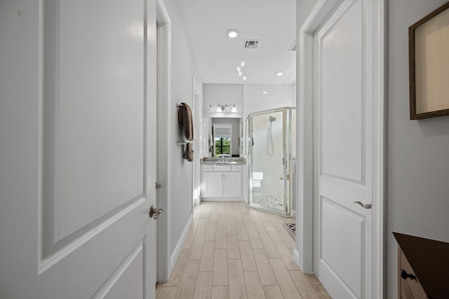 corridor featuring light hardwood / wood-style floors