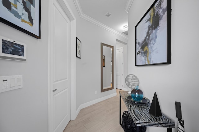 corridor with crown molding and light hardwood / wood-style flooring