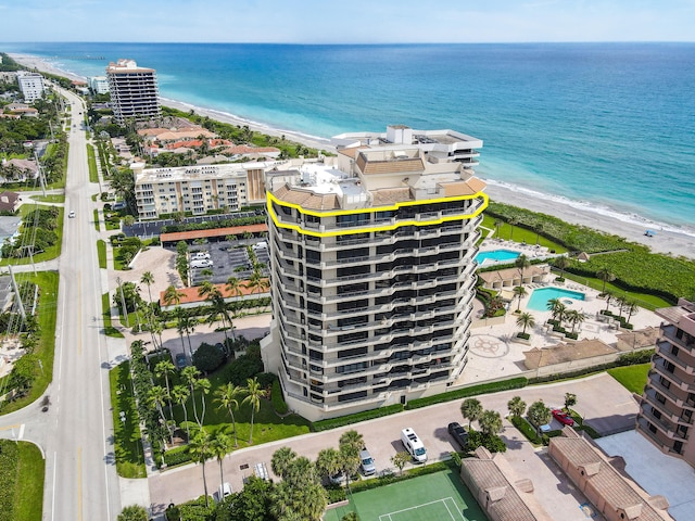 birds eye view of property with a water view and a view of the beach