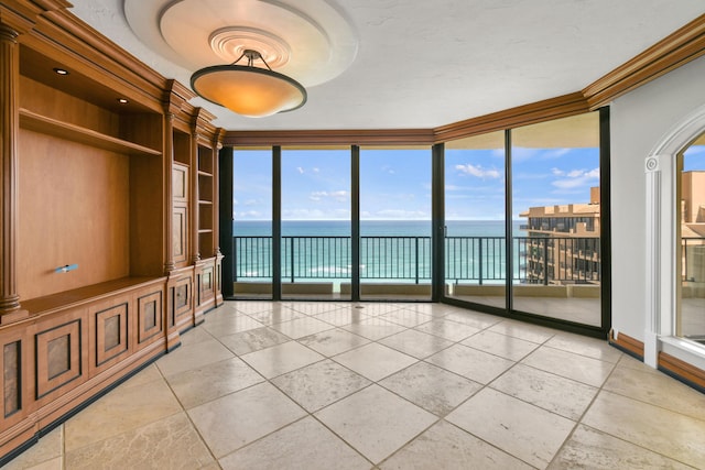 570 Ocean Dr Unit 1302, Juno Beach, FL 33408 - unfurnished room featuring a water view, floor to ceiling windows, and crown molding