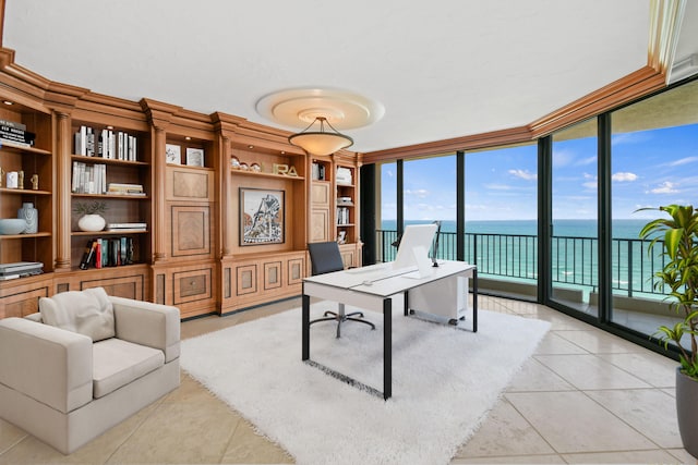 office space featuring a water view, light tile patterned floors, and a wall of windows