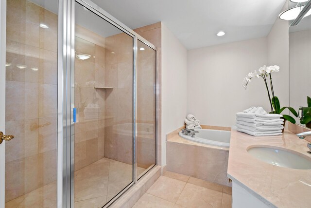 570 Ocean Dr Unit 1302, Juno Beach, FL 33408 - bathroom with a bath, tile patterned floors, a shower stall, vanity, and recessed lighting