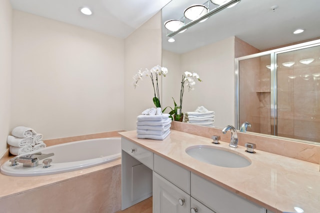 bathroom with separate shower and tub and vanity