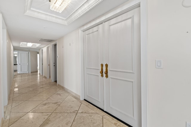 hall with an inviting chandelier