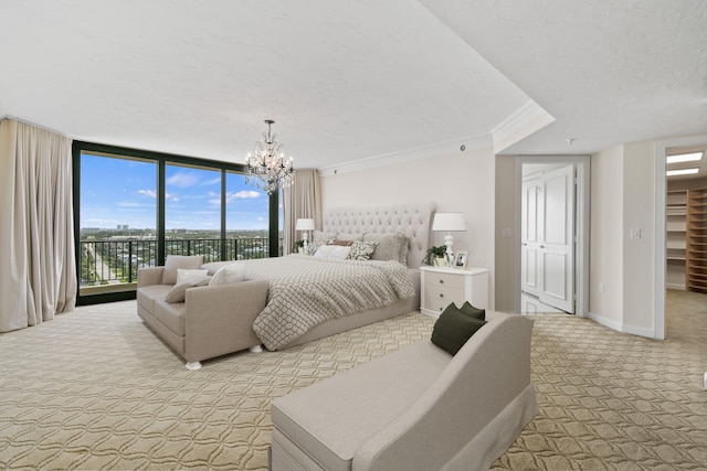 carpeted bedroom with expansive windows, crown molding, access to exterior, a spacious closet, and a closet