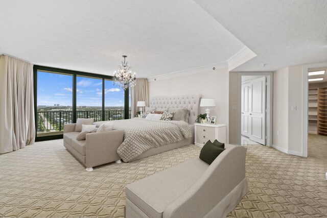 570 Ocean Dr Unit 1302, Juno Beach, FL 33408 - bedroom with light carpet, ornamental molding, access to outside, a textured ceiling, and a wall of windows
