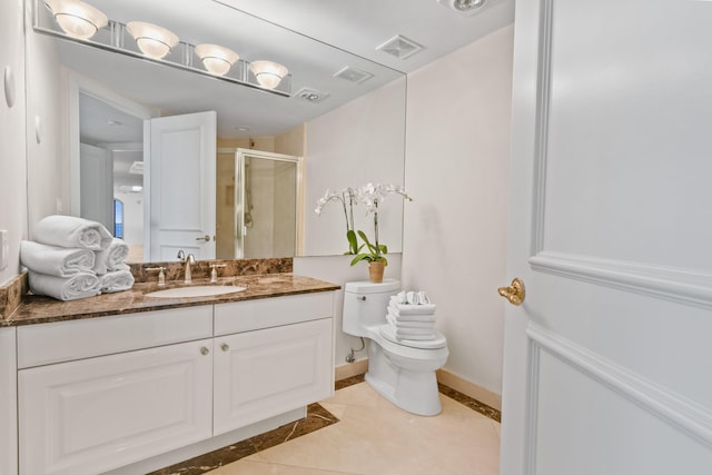 bathroom featuring tile patterned flooring, vanity, toilet, and an enclosed shower