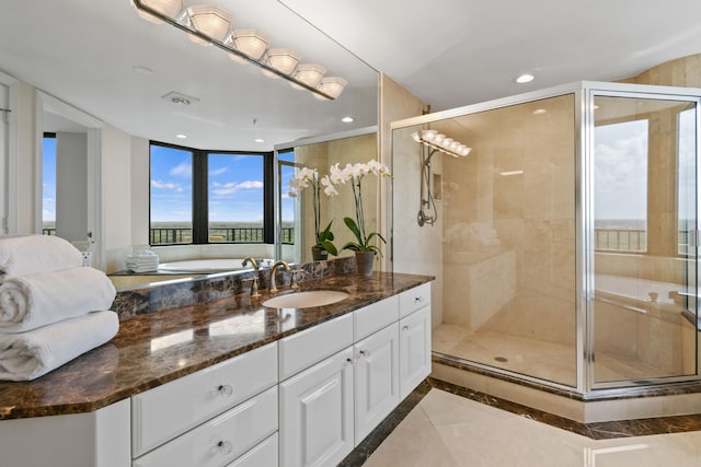 bathroom featuring tile patterned floors, vanity, a healthy amount of sunlight, and an enclosed shower