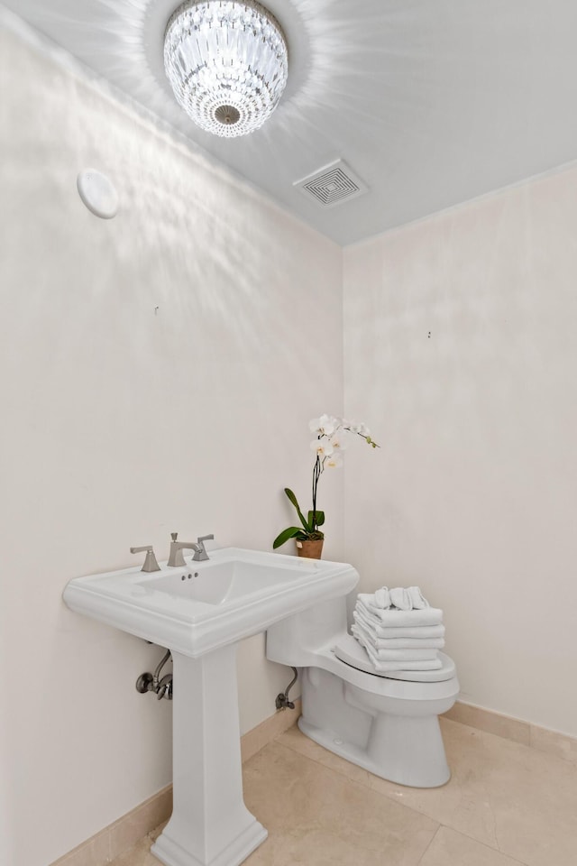 570 Ocean Dr Unit 1302, Juno Beach, FL 33408 - half bath featuring toilet, tile patterned flooring, and baseboards