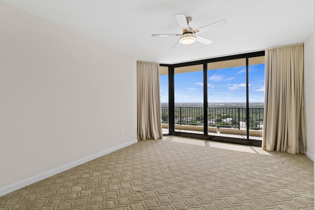 570 Ocean Dr Unit 1302, Juno Beach, FL 33408 - empty room with floor to ceiling windows, ceiling fan, carpet, and baseboards