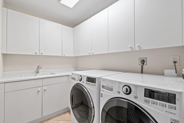 laundry room featuring cabinets, separate washer and dryer, and sink