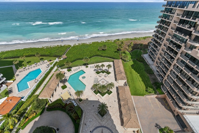 drone / aerial view featuring a water view and a beach view