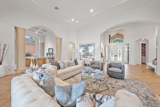 tiled living room with decorative columns, french doors, a high ceiling, and crown molding