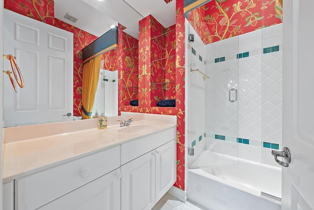 bathroom featuring vanity and bath / shower combo with glass door