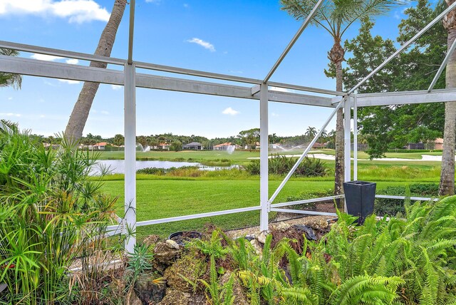 unfurnished sunroom featuring a water view