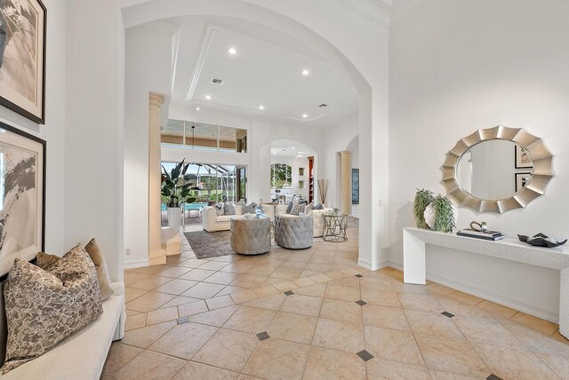 interior space featuring a towering ceiling and light tile patterned floors