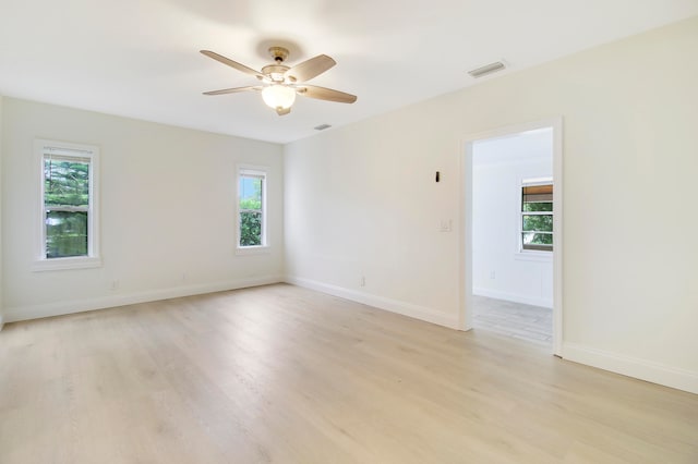 unfurnished room with light hardwood / wood-style floors and a wealth of natural light