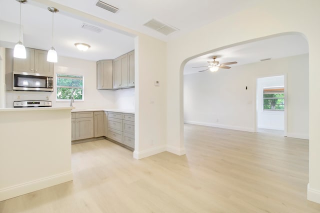 kitchen featuring ceiling fan, white range, and light hardwood / wood-style floors