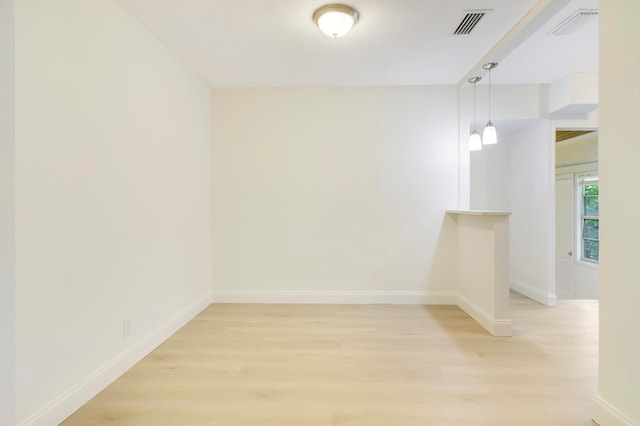 spare room featuring light wood-type flooring