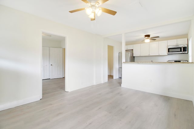 interior space featuring ceiling fan and light wood-type flooring