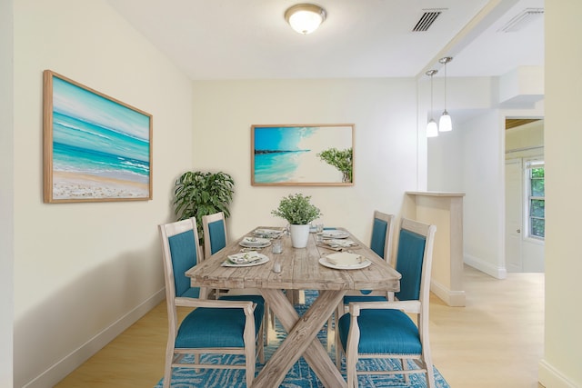 dining space with light hardwood / wood-style floors